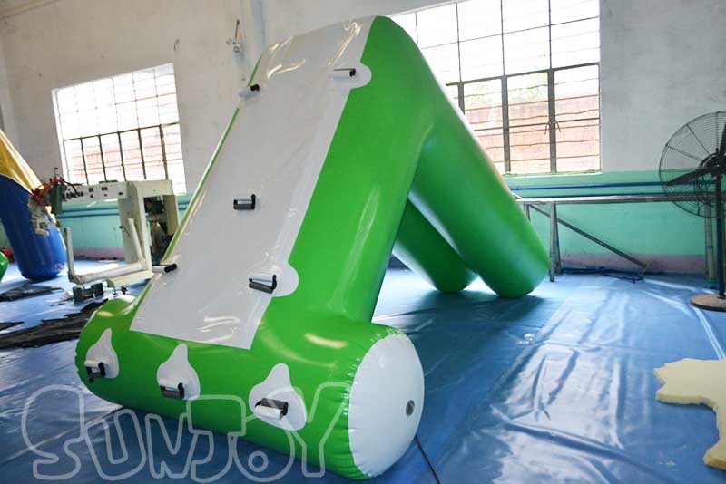 green white inflatable floating slide