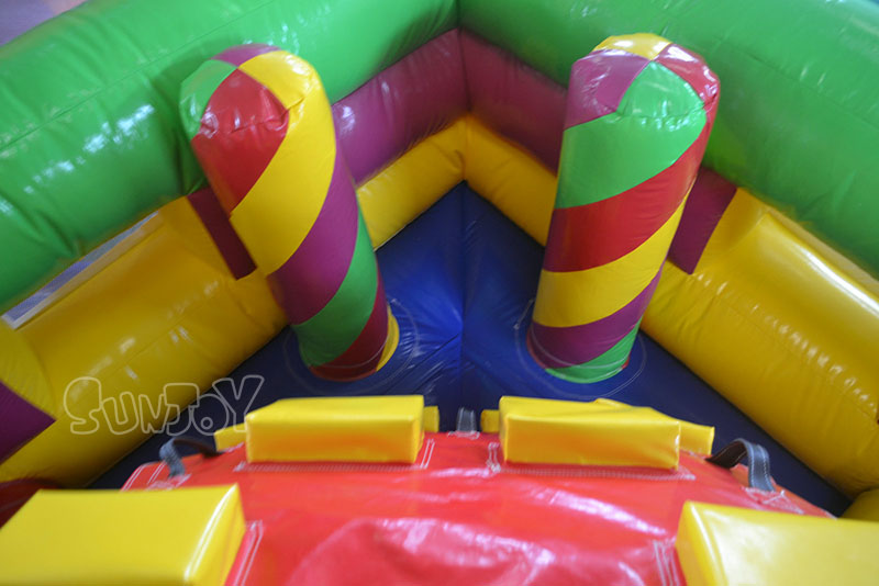 dual slide playground behind obstacle