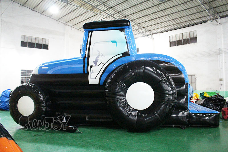 blue tractor bounce house side view