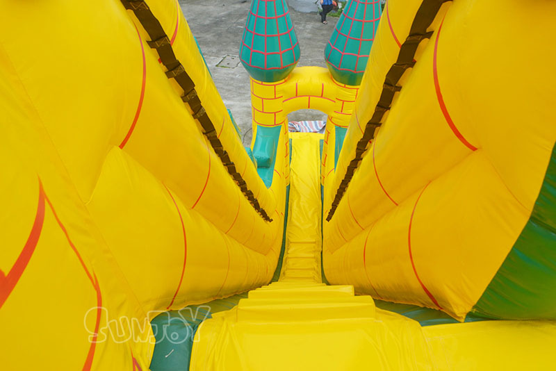 yellow castle inflatable slide climbing stair